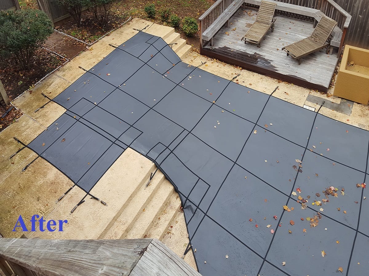 Same pool with a custom mesh safety cover fitted over the steps and spa